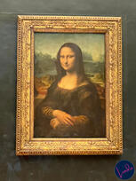 The Mona Lisa at the Louvre Close-up of the Mona Lisa painting behind glass at the Louvre Museum in Paris